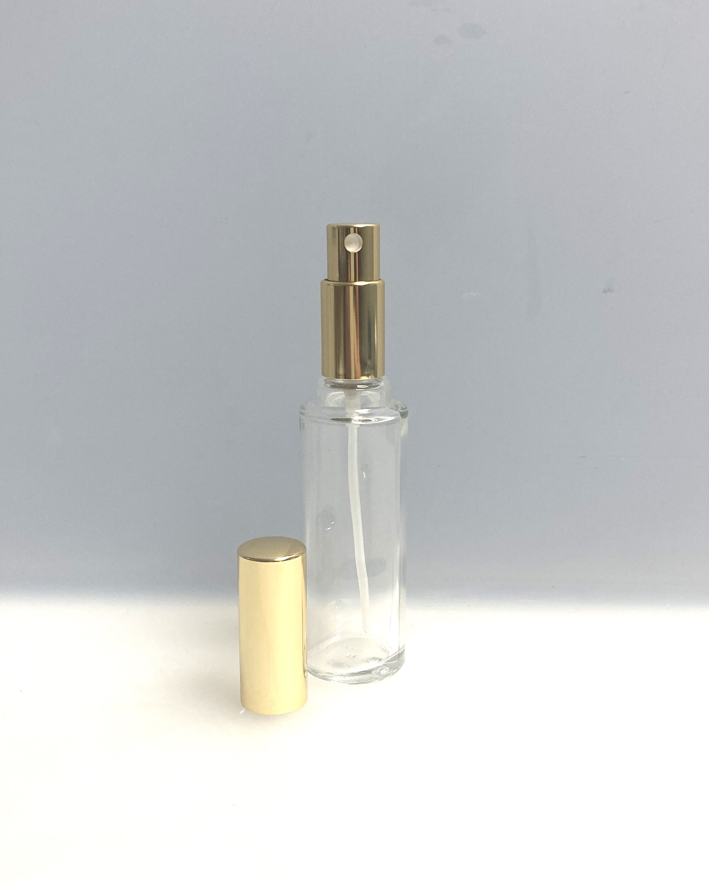Parfümflasche rund mit Zerstäuber und Deckel goldfarben